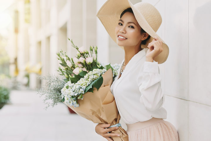 elegant well dressed asian woman with flowers